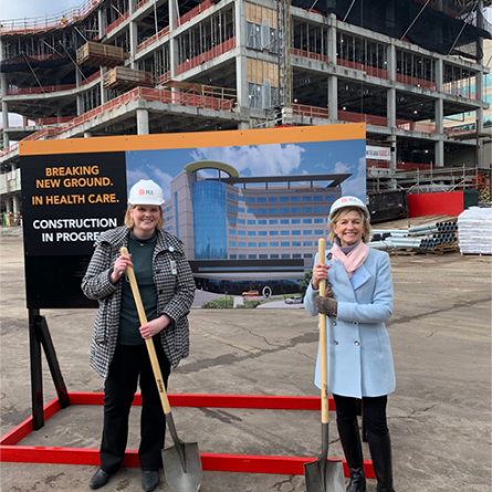 Linda Nelson with another woman breaking ground at a construction site